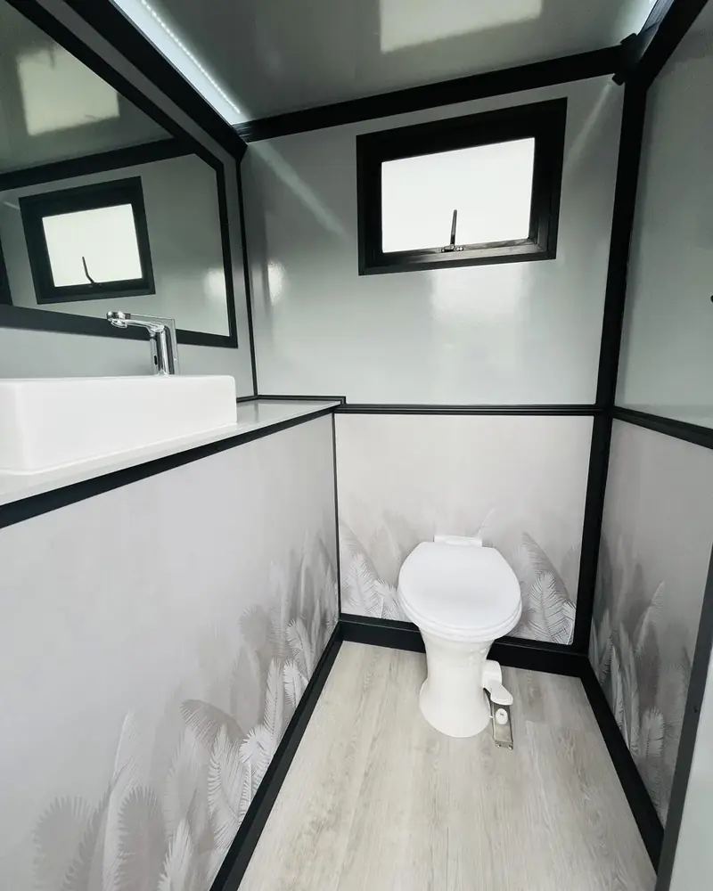 Restroom trailer stall interior with window