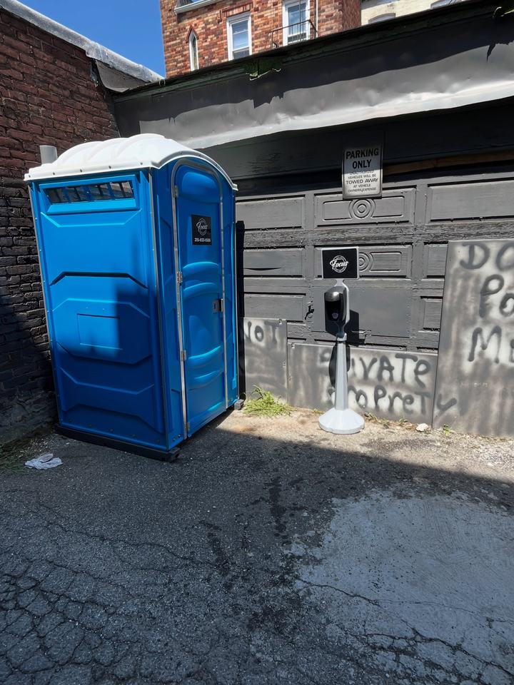 Porta potty in a driveway