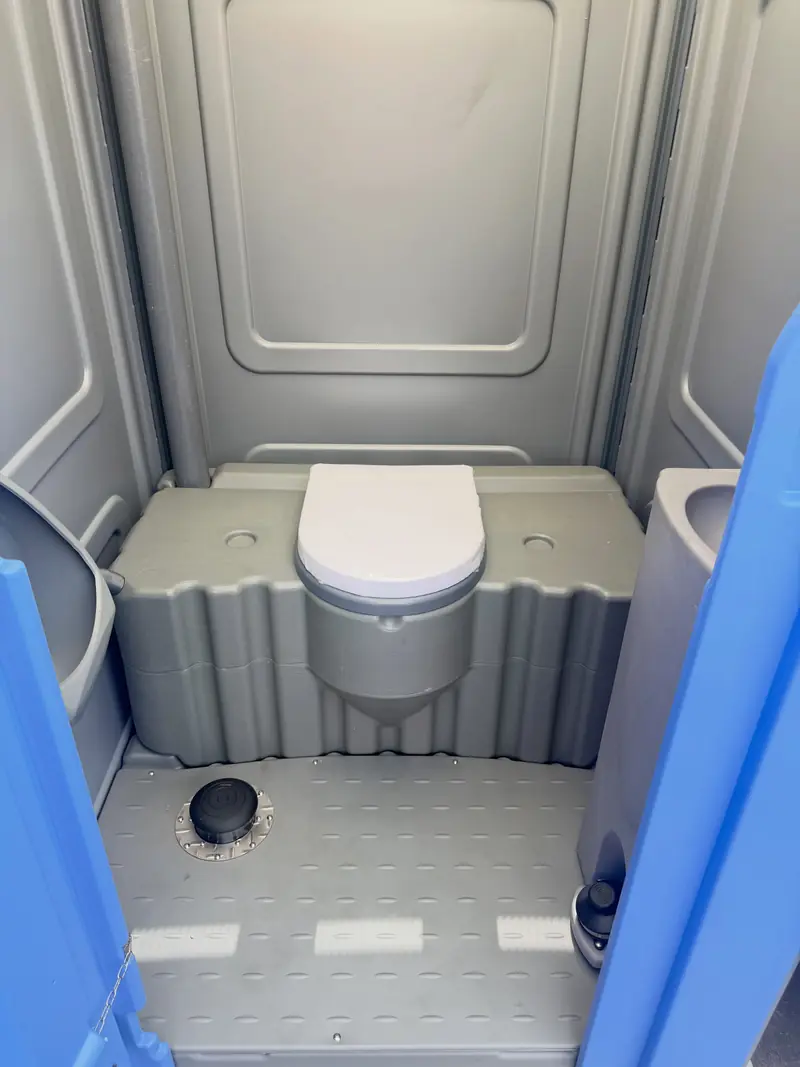 Inside a clean standard porta potty after service