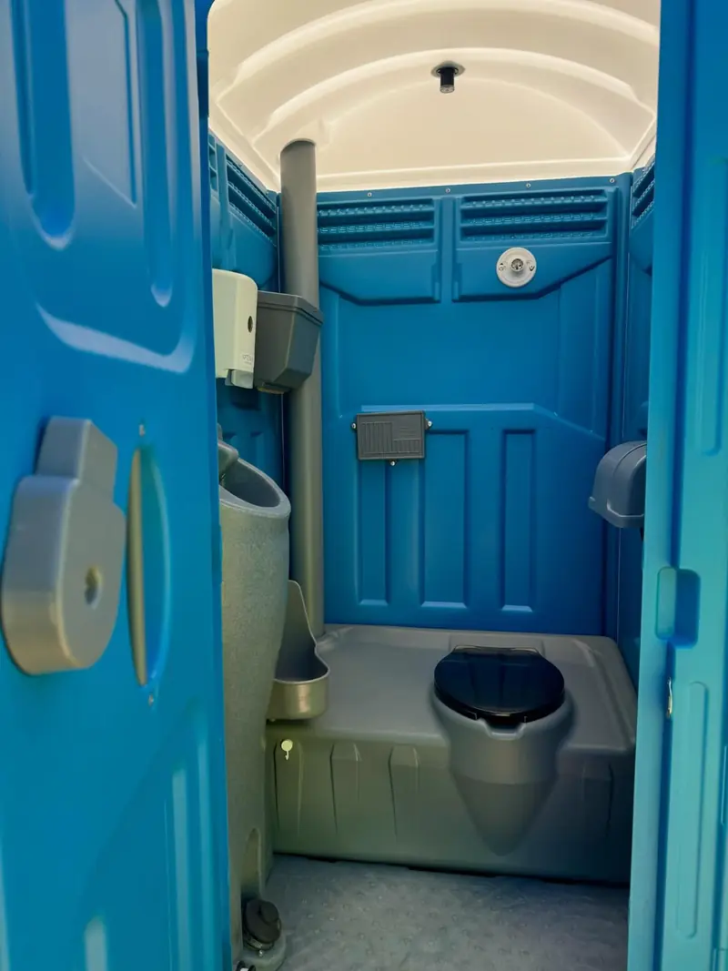 Inside a clean, stocked standard porta potty