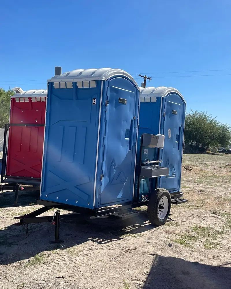 Towable porta potty trailer on a job site